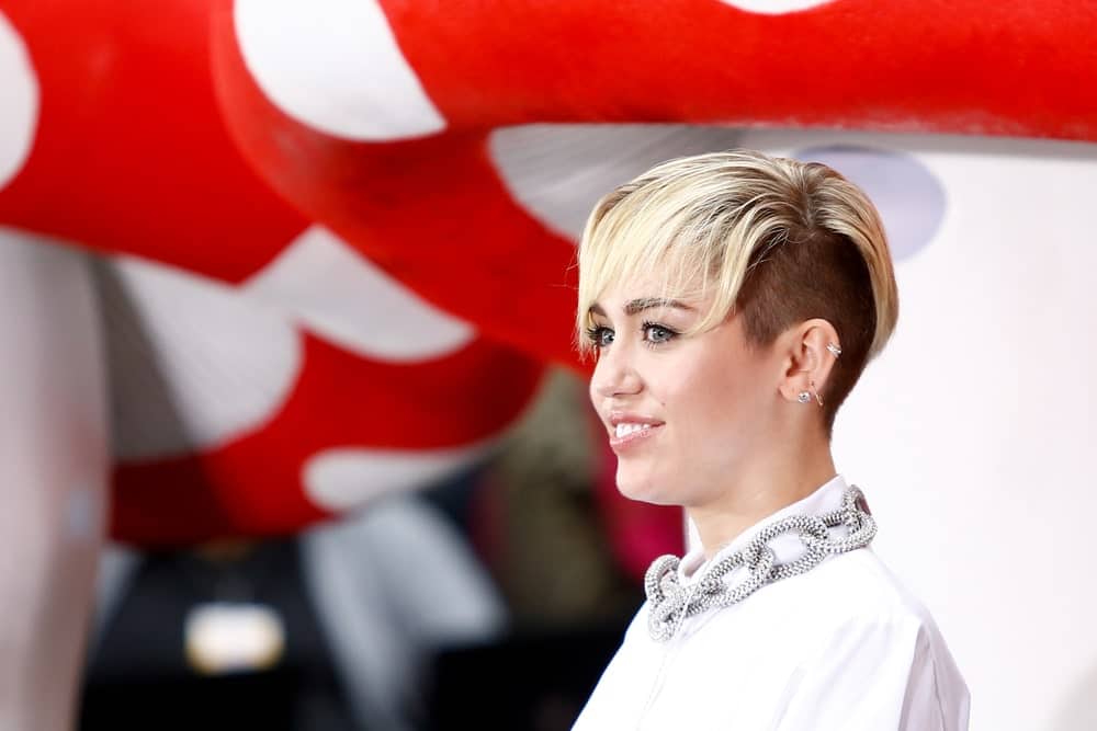 Want to take it a step further? Shave one side of the head to sport short cropped hair and balance it off with elegant bangs covering your forehead. Miley truly pulls off this hairstyle!