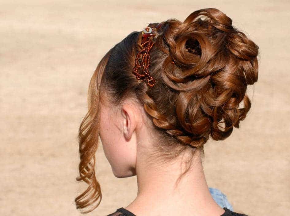 This hairstyle for women with long hair features an extra elaborate bun that is sure to turn heads wherever you go.