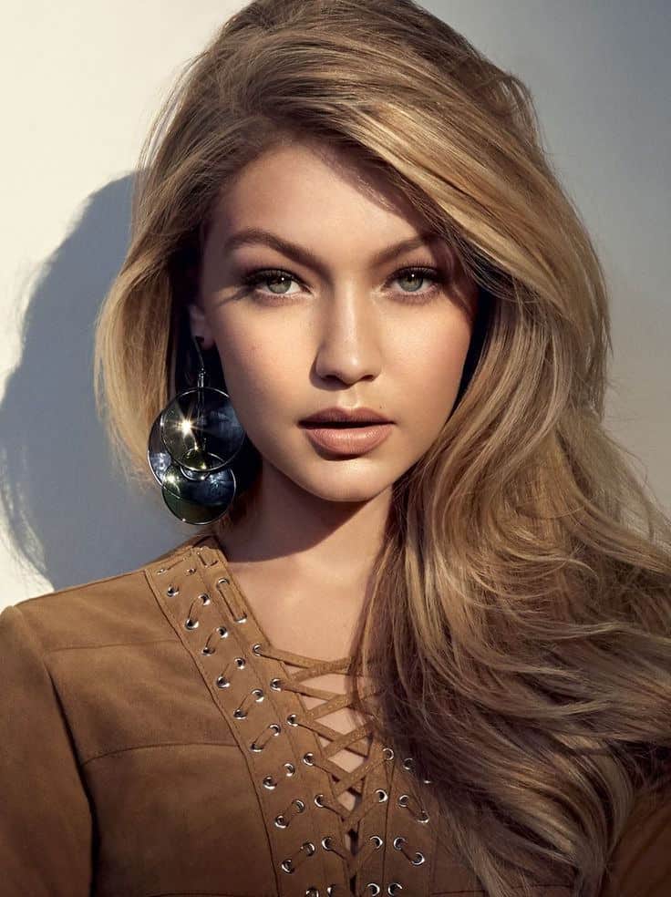 If you have caramel-colored hair like Gigi Hadid, try a super-glam look by adding lots of gold highlights to your locks and sweep it to the side for a multi-dimensional look.