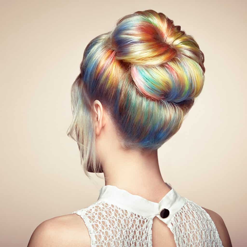 If you are in the mood for having some fun with your long hair, then pastel rainbow highlights might just be the thing for you. Wear your dyed hair in a high donut bun to let those colors dazzle everyone.