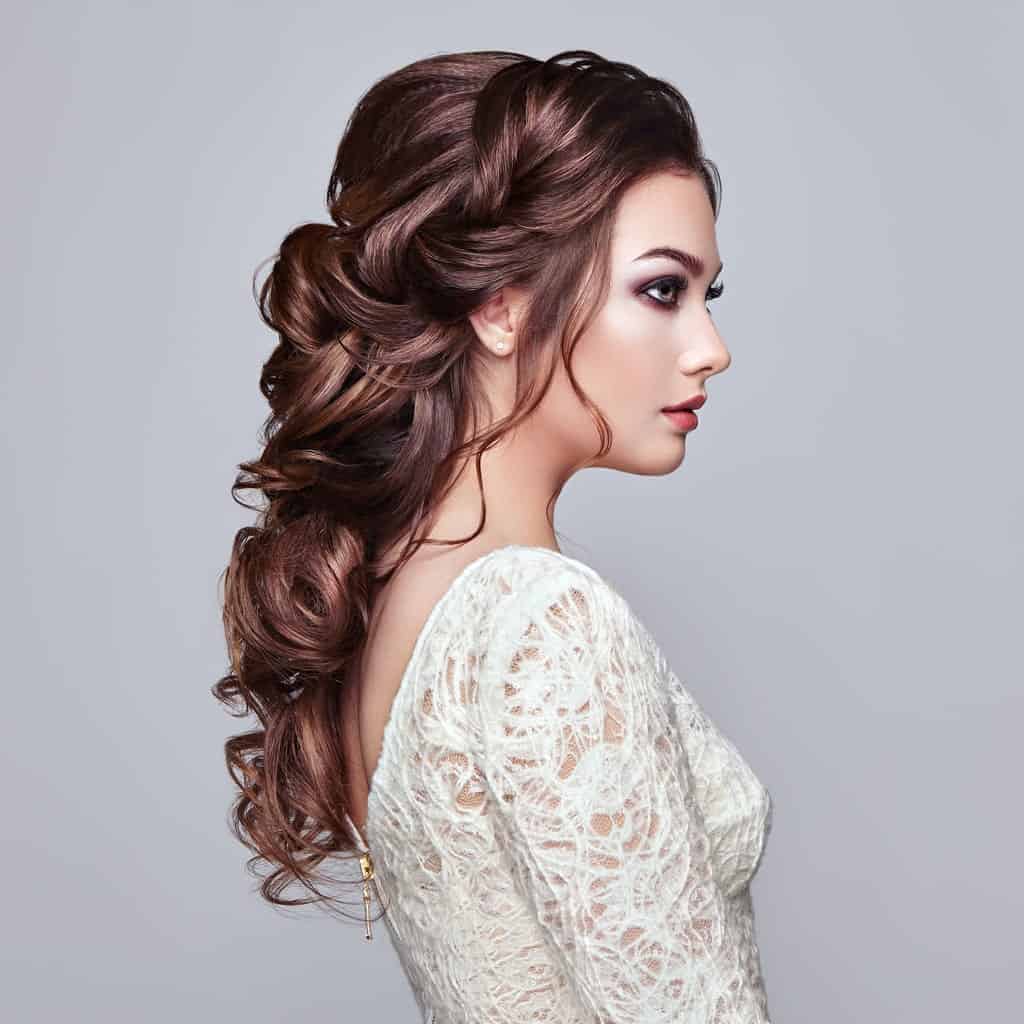This hairstyle for women with long hair is all about sophistication and elegance. A low ponytail braid is the go-to hairstyle for wedding parties.