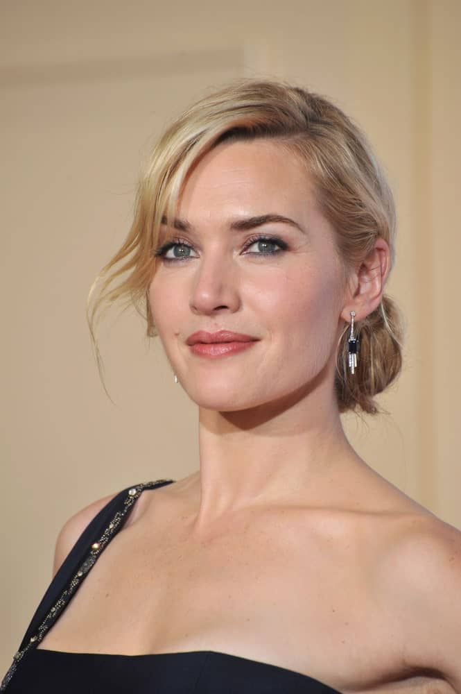 This side-swept bangs hairstyle sported by Kate Winslet shows how wavy bangs and a neat bun look glamorous and elegant.