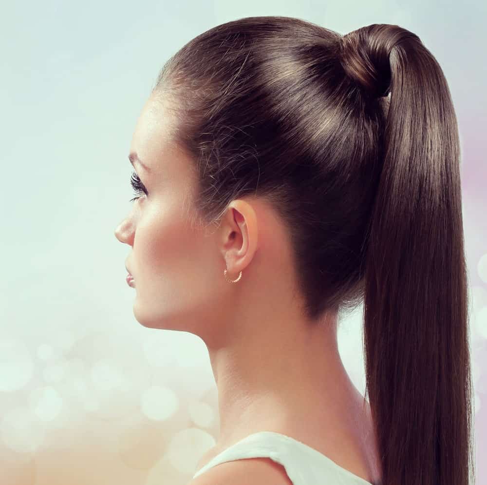 If your hair is silky straight and brunette, this is the hairstyle for you! The hairstyle features long brunette hair tied in a high ponytail at the back. However, if you look closely, it is no ordinary ponytail. Thick and lustrous locks of hair replace the hair tie and hold the rest of the hair in place. This is one of the “neat” hairstyles that make sure you don’t have to wipe out hair out of your face and eyes every two seconds. Whenever you are in a hurry but want to look your best, go for this sleek and stylish ponytail.