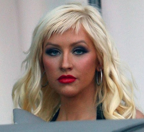 The spiky blond short bangs are the perfect complementary haircut to the wavy hair that Christina Aguilera has. They make her forehead look smaller and give her intense, smoky makeup the perfect boost.