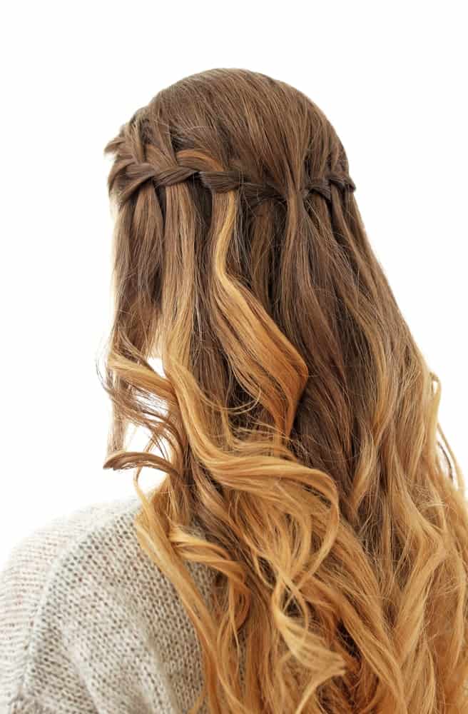 This is the most romantic looking braided hairstyle ever.  First, part your hair from the middle. Take a few hair strands from your right section and divide it further into three sections. Cross the top side of the section over the middle one which will hang loosely to create a waterfall look.  Do the same with the bottom side with new middle hair strands, repeat the process until you have reached the end of your hair length.