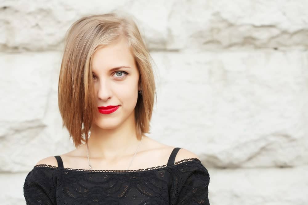 Slightly longer than the classic bob, this edgy look gives just the right look of punk. The cropped hair is chopped unevenly to give the hair more texture. The young woman has also done a “reverse ombre” with her very pale, platinum locks, turning to a reddish, sandy shade at the bottom.