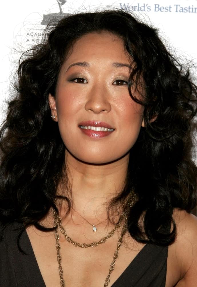 This is the famous Grey’s Anatomy star Sandra Oh with slightly messy curls all the way from top to bottom. 