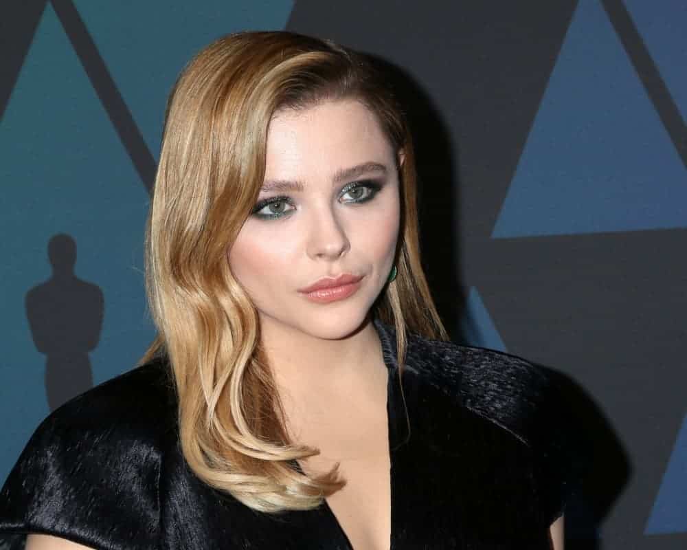Chloe Grace Moretz was at the 10th Annual Governors Awards at the Ray Dolby Ballroom on November 18, 2018, in Los Angeles, CA. She wore an all-black dress to pair with her side-swept wavy sandy blond hairstyle with a slick finish.
