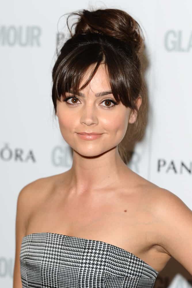 Jenna Louise Coleman arriving for the 2013 Glamour Women of The Year Awards. Her simple look is paired with a messy upstyle with curtain bangs, perfect for hair with thick strands.