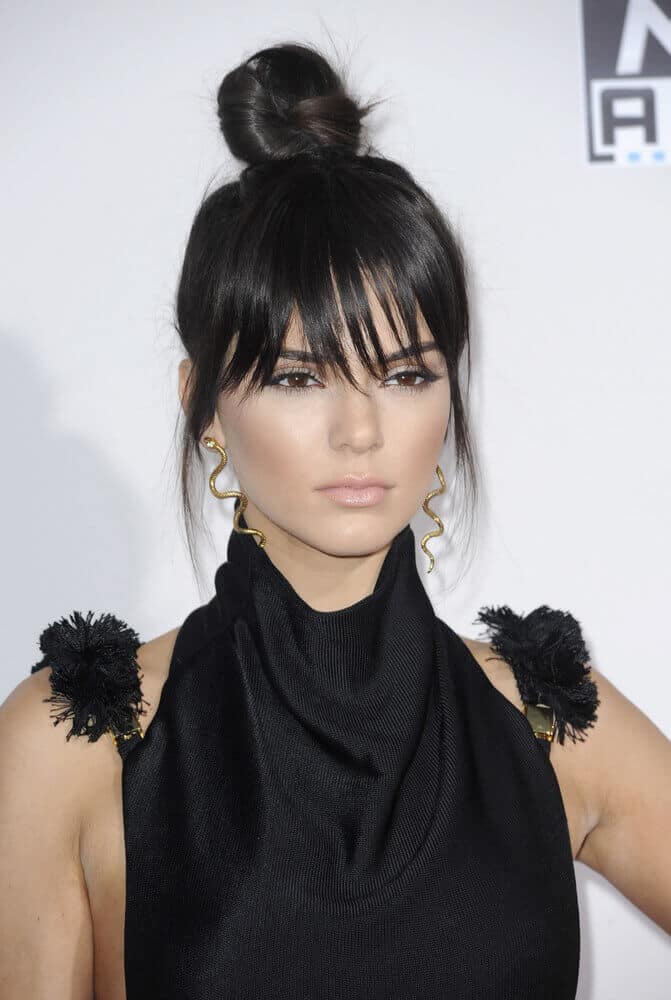 Kendall Jenner slays this cute yet edgy hairstyle during the 2015 American Music Awards. Her extra high bun is paired with wispy bangs to balance out the whole look.