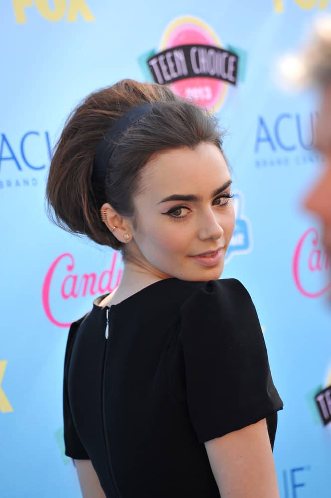 Lily Collins channeling her inner vintage babe with this elegant-looking bouffant incorporated with a black headband for a trendy finish. 