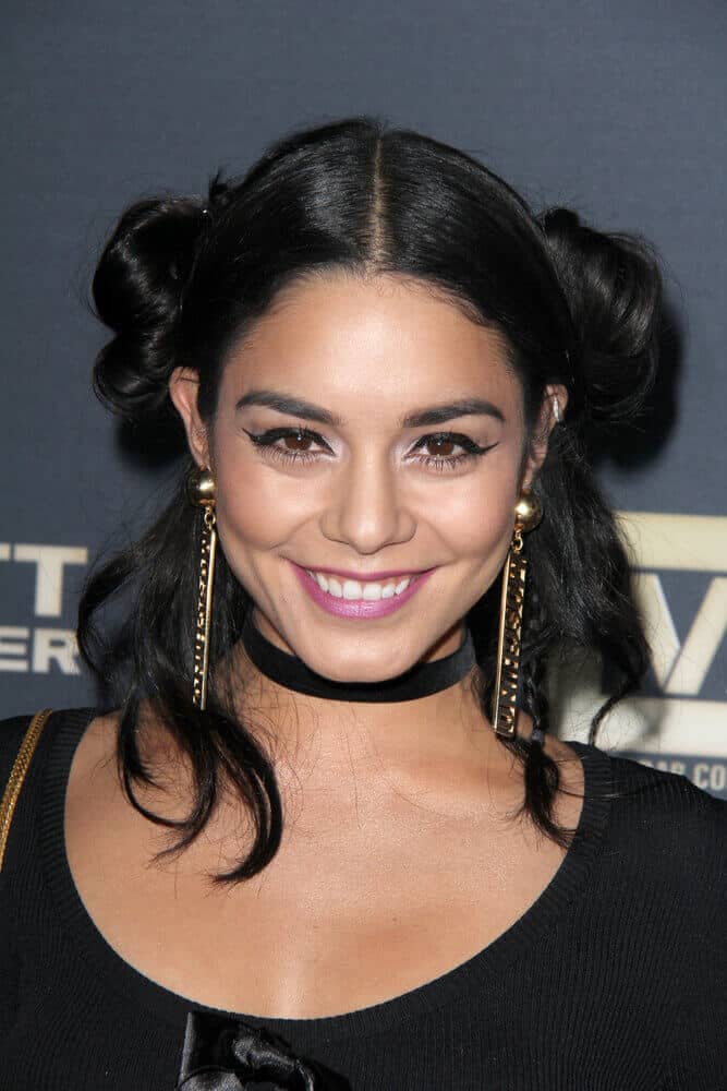 Vanessa Hudgens looking cute and playful with her black hair partitioned into two loose buns. This style, paired with winged liners, is a famous Asian trend.