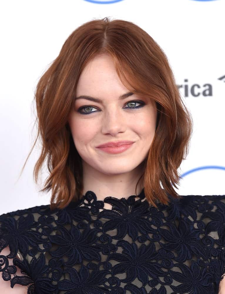 The look works best on second-day hair. If you don’t want to do that, use some texturizing spray to make your jagged layers stand out, like Emma Stone. Part your hair in the middle for a chic and effortless look. Half Topknot