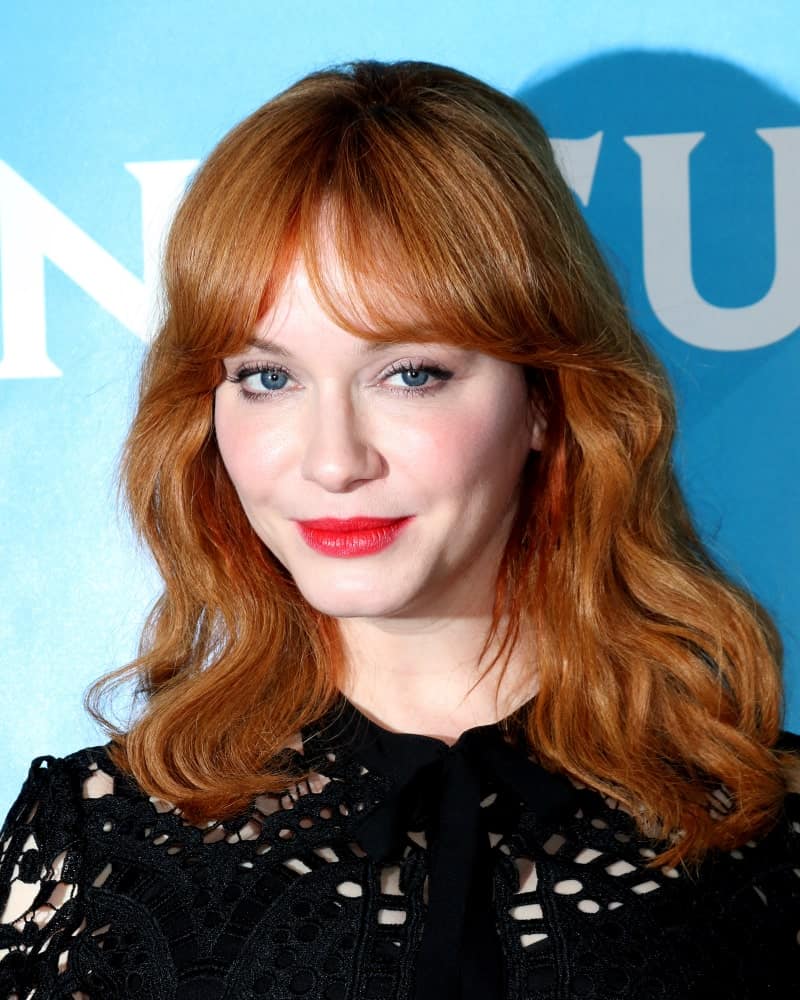 Natural redhead Christina Hendricks sports this uncomplicated hairstyle for women with slightly curled hair type. Curtain-style center-parted bangs coupled with curly hair divided and sported on both shoulder will look intense despite the simplicity if you have eye-catching auburn hair like hers.