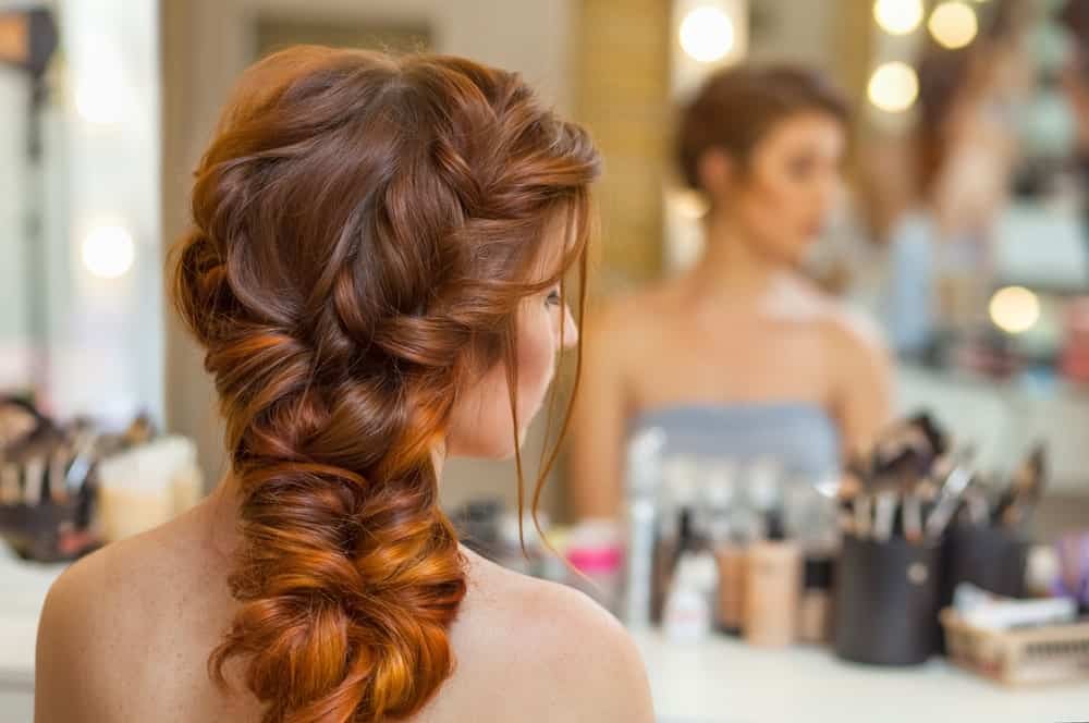This is the perfect formal hairstyle for long dyed hair. With braids, twists, and twirls, the redhead hairstyle looks absolutely stunning. Whether you are going for a fancy dinner, attending a wedding, or an office dinner, this hairstyle is perfect to add the touch of elegance that you need. Notice how the hair dyed in different tones play a part in bringing focus to the hair and defines the hairstyle. 