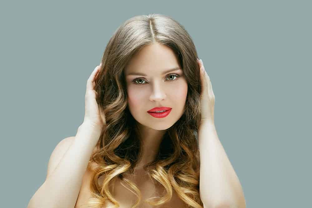 This is a simply beautiful highlighted look with soft brown hair at the top and light gold highlight at the bottom of the hair. The hair towards the bottom has been styled into soft curls which helps bring out the color of the highlights.