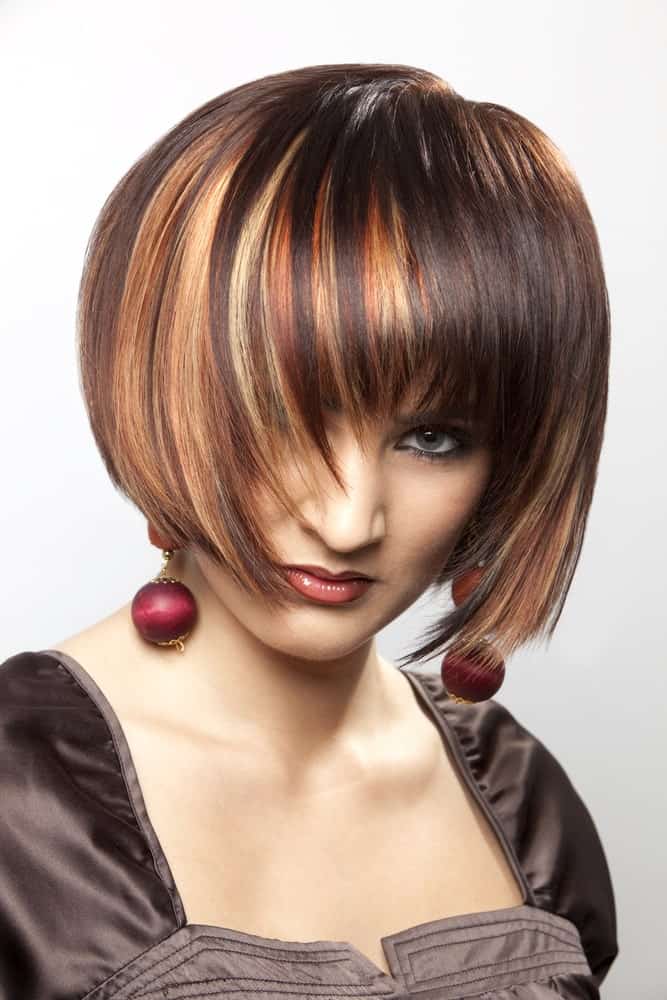 Anyone aiming for a bold and fierce hair look should definitely get this. This is a short, sleek bob with a lot of colors like orange, red, brown and yellow. These highlights are absolutely stunning and funky. 