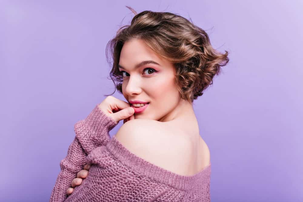 This is one of those bold and daring short hairstyles that not everyone can pull off easily. It is an extremely short hairdo with beautiful waves like curls that appear to be super bouncy and voluminous. The hair has quite a texture to it that gives it an airy kind of an effect.