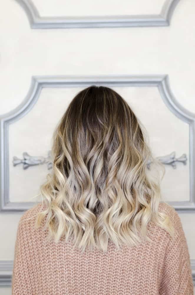 This is a stunning balayage highlighted look with dark shaded hair at the top followed by a mixture of silver, ash and blonde low lights that have been slightly curled from the bottom, making it look simply gorgeous.