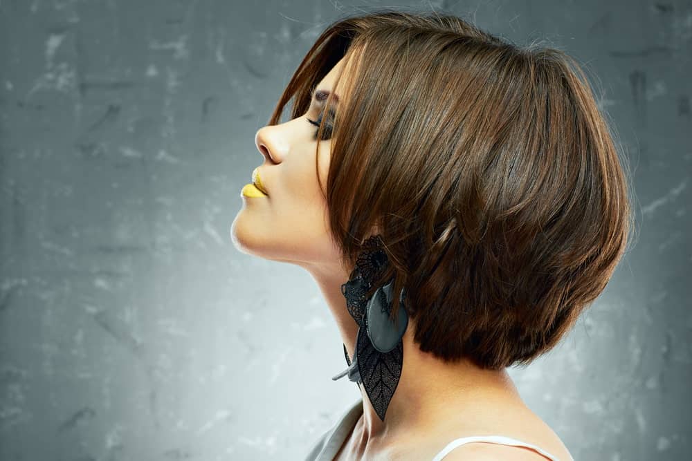This is an absolutely breathtaking short hairstyle with a lot of layers of short hair on top of each other that are super straight, sleek and glossy. The hair length is till the nape of the check which is what really that gives it the edgy kind of a look.
