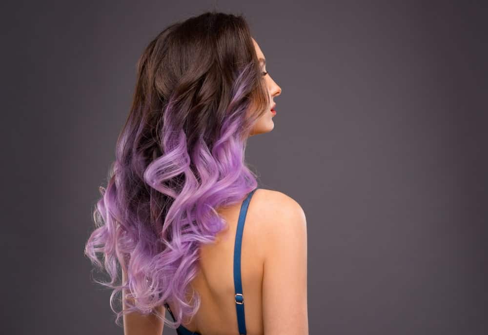Another bold look, this style consists of purple hair highlights that are almost similar to lavender. This is ideal for those who love to experiment with their hair and have a thing for flashy and bold colors. 