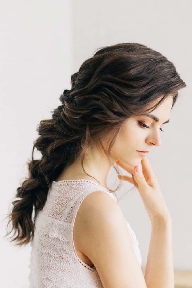 If you’re worried the only way to style wavy hair is to leave it open, think again! Try a wavy, textured braid loosely pulled back for a beautiful, ethereal finish. 