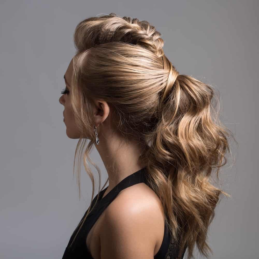 Wavy hair can look absolutely stunning in a thick, lifted ponytail. Add a fishtail braid to the crown of your head and leave a few locks streaming down your face for a feminine touch. This is not your classic ponytail – it’ll be sure to turn heads everywhere you go! 