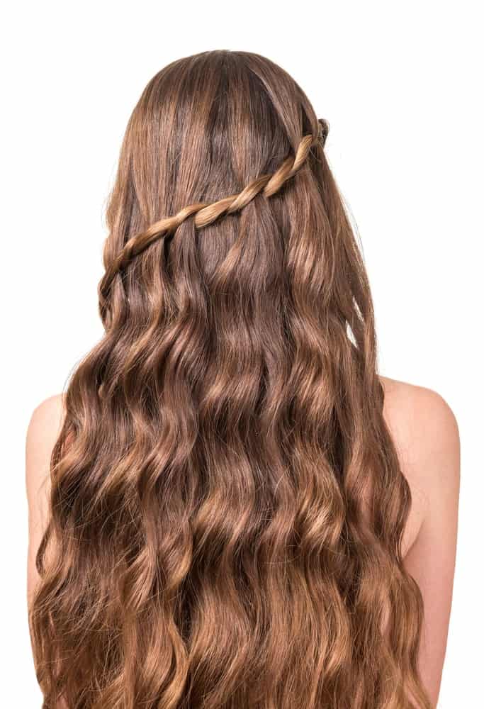 A swooping waterfall twist can be a beautiful addition to hair that is wavy throughout. It’s a hairstyle that makes it feel like your hair is flowing from the twisting strand of hair and will definitely be a hairstyle to stand out in the crowd. 