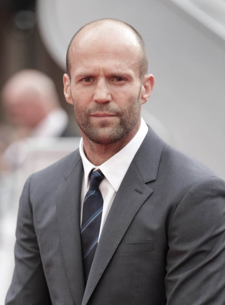 Yet another actor rocking a shaved head, Jason Statham looks super chic and bold in this natural bald haircut with light facial scruff. The oval-shaped face cut further enhances his shaved look. This green-eyed star from Now You See Me looks absolutely graceful with his shaved look. The prominent face structure and the sleek jaw-like greatly enhances the look along with the big, beautiful eyes, of course!