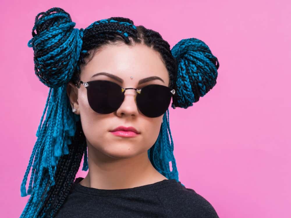 For some extra edgy and hipster vibes, try this fun style. Ask your stylist to twist your hair into Fulani braids and weave it together with Smurf-blue threads and tassels. These tassels can be much longer than the actual length of your hair. However, if you feel that all the extra length is cumbersome, just part your braids into two sections and wrap it into twin buns on the side of your hair, Princess Leia style.