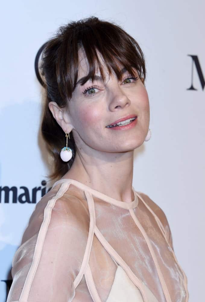 Michelle Monaghan appears far younger than her actual age when sporting this lose ponytail accompanied by deep eye-skimming and airy-separated bangs. A loose hairstyle like this one gives you a bubbly and sporty image.