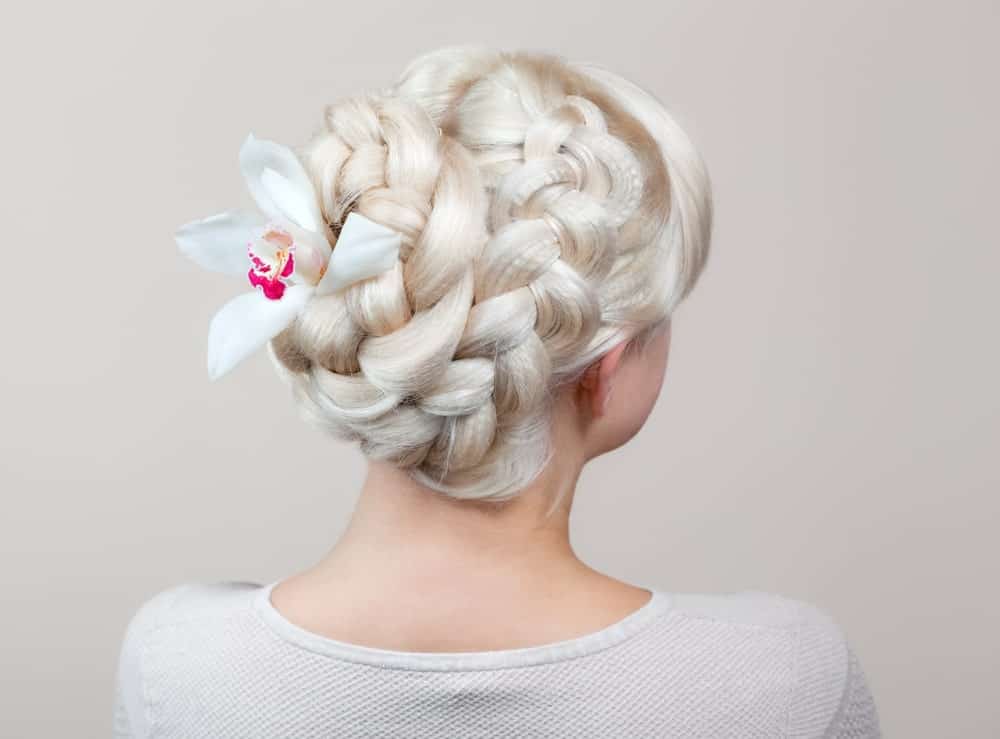 Since paler than pale hair is all the rage these days, many girls are opting to walk the aisle with platinum or white-dyed hair. For a great wedding look, those with long hair can create beautiful and elaborate updos. This style features two thick braids that start from the crown of the head and coil at the back to make an easy-to-do yet elaborate looking hairstyle.