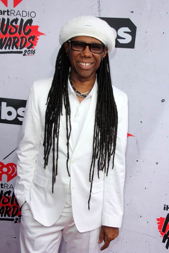 These have to be the ultimately classic dreadlocks being rocked by none other than Nile Rodgers, the American record producer, musician, and songwriter. He has super long dreads that have been let loose in the front on both the sides. He has further upped the look with the help of a white hat that acts as a great contrast against his jet-black dreadlocks. 