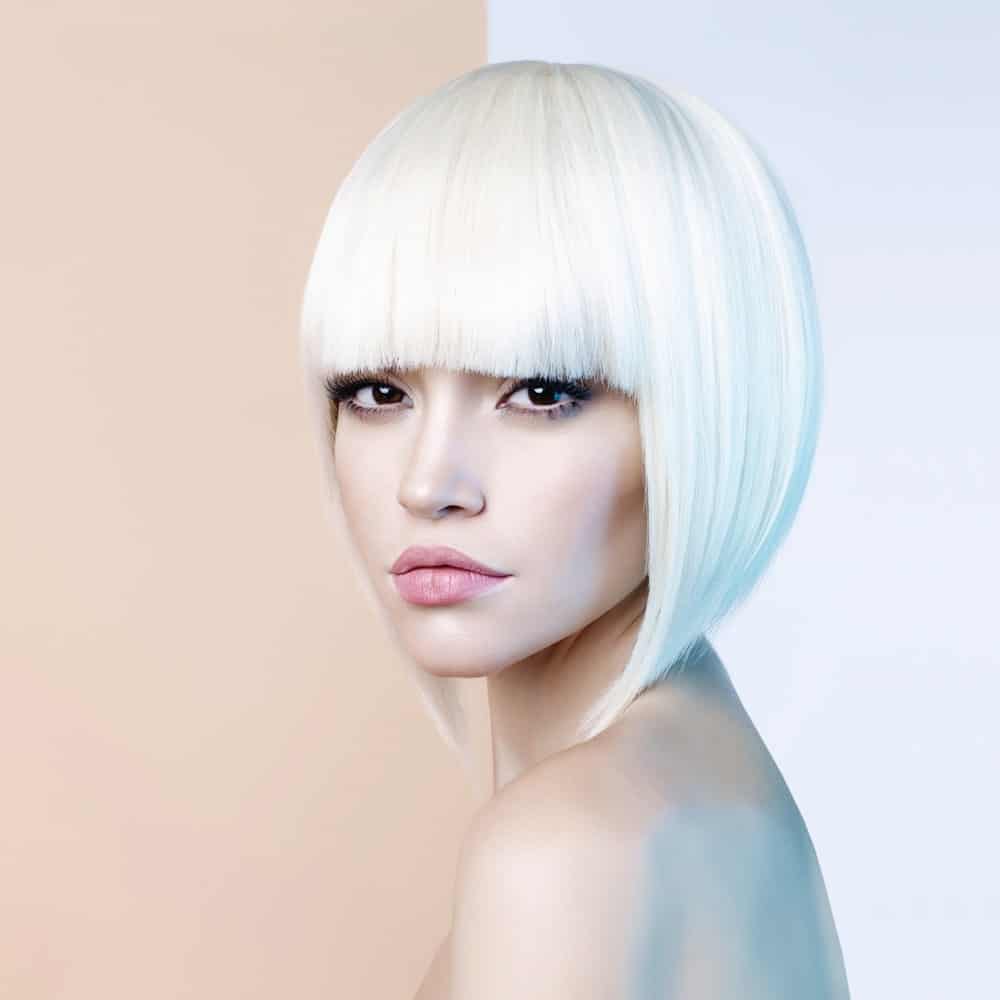 For a sophisticated and futuristic look, make your hair go a brilliant white. Get your stylist to cut it into an angled bob, which ends an inch or two above your shoulders. Perfect the look with straight blunt-cut, eyelash-skimming bangs. 