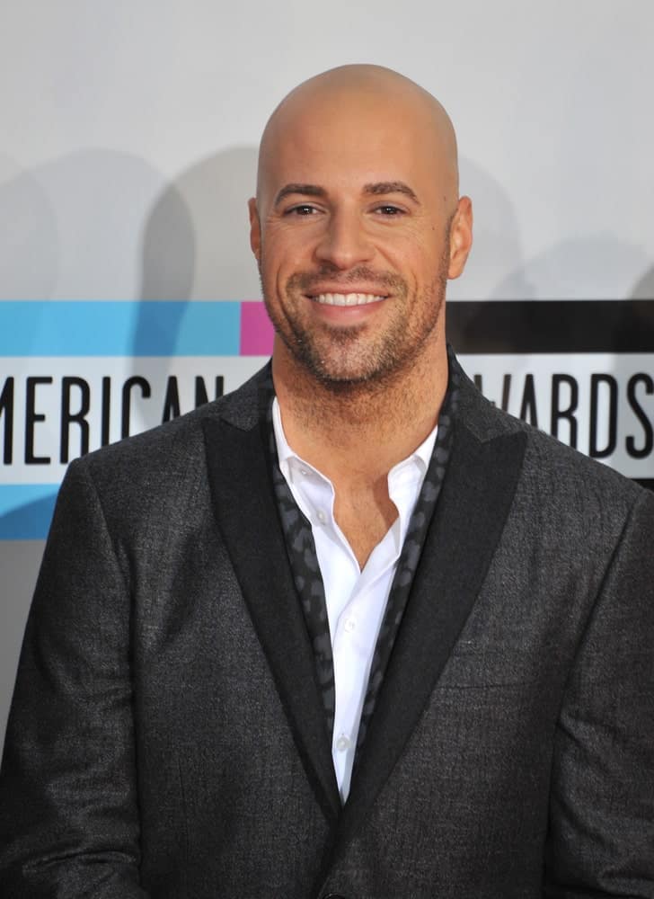 The ever handsome and gorgeous, Chris Daughtry looks like a dream come true in this clean-shaved haircut. It is very rare that a man pulls off a shaved head so flawlessly and he is definitely one of those who do! Those sparkling eyes, the million-dollar smile and the edgy-rough kind of facial scruff just simply complements the shaved head perfectly!