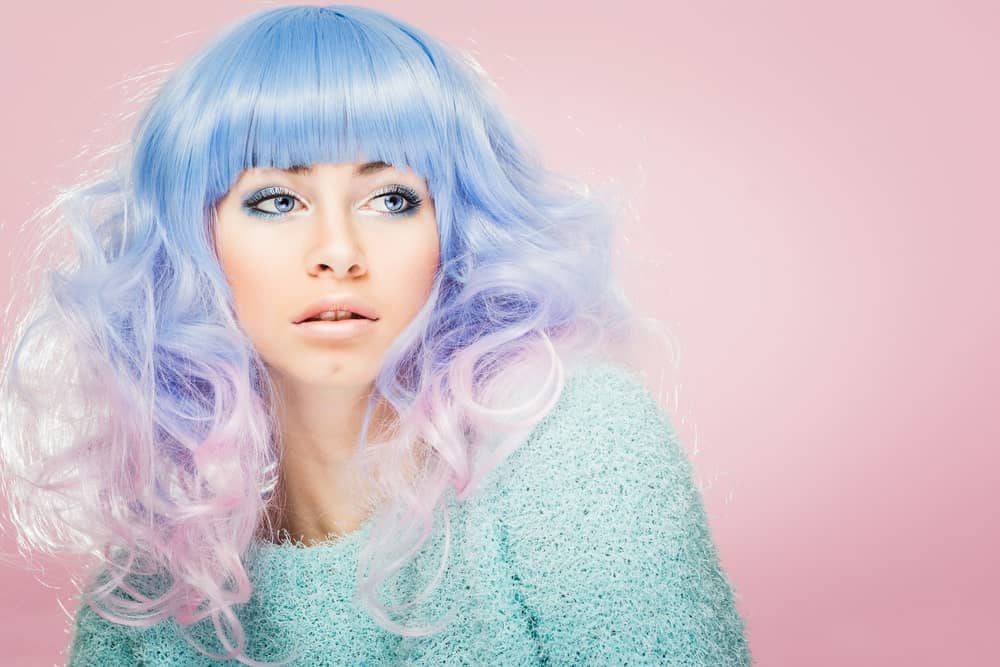 This is a very flirty and adorable look for ladies with superfine hair.  This model rocks pastel periwinkle and candy pink hair which melt together in the middle to give a soft lilac shade. The colors make her hair look like cotton candy and the style is popularized by anime characters.