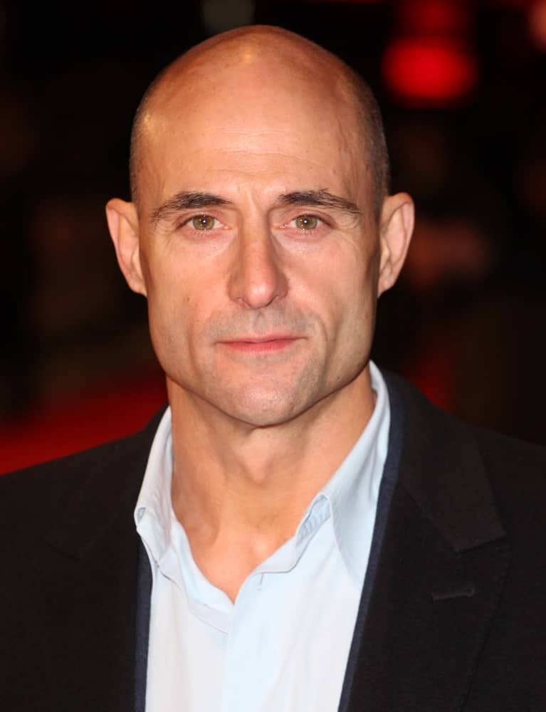 With that extraordinarily sleek jaw-line, prominent high cheekbones, and those big gleaming eyes, Mark Strong pulls off this classic shaved head with utter grace and simplicity. The structure and cut of his face make his chin very noticeable, adding to his charisma! 