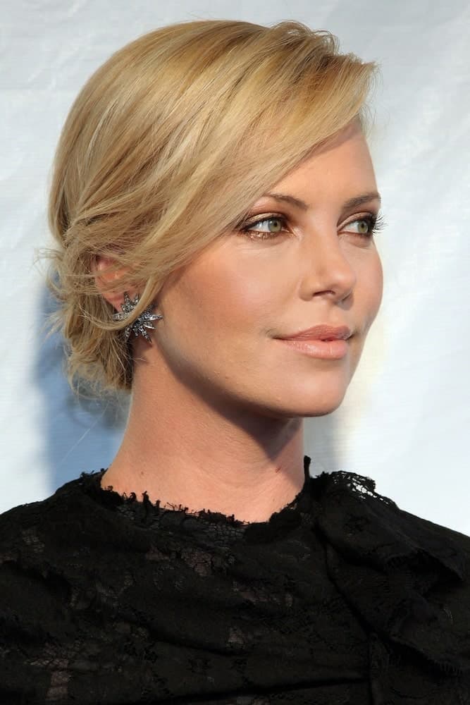 Charlize Theron’s low-tied chignon is a good style to consider if you are running late and cannot afford extra time styling your hair. Simply comb it once, knot it lowly at the nape of your neck and you are ready to rock just like that.