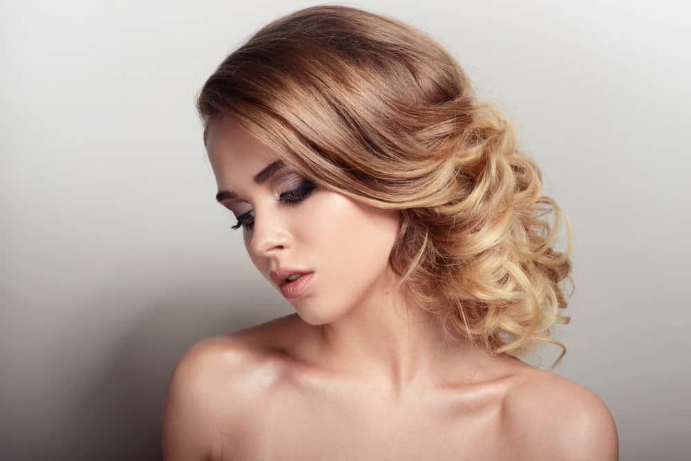 Want to try an elegant party or a wedding-hair look? Wear your mid-length hair in a low bun. It’s easy. Keep the top and front of your hair straight, while curling the bottom of the hair around a hot tong to get lots of wispy curls. Then take some bobby pins and either pin your curls to one side or roll them up. Fix the bun to the back of your neck to create this beautiful look!
