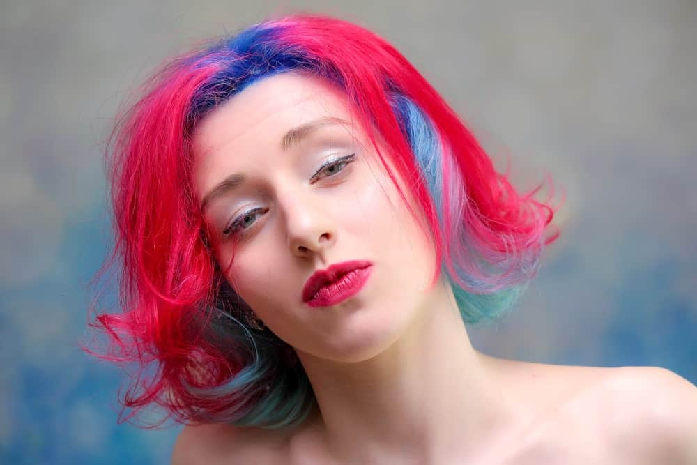 If you love the primary colors flaunted by Old Glory and Superman, this is the perfect style for you. Keep your roots a royal blue while dyeing the rest of your hair a bright, ruby red. To give your hair some dimension, color a few strands in your red hair blue too. This is a fun and vibrant look for the summer.