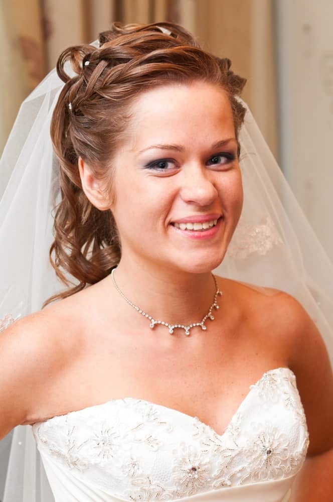 Loose braids that merge into a wavy ponytail and are decorated with a few beads are a classic look that many to-be-brides are a fan of. 