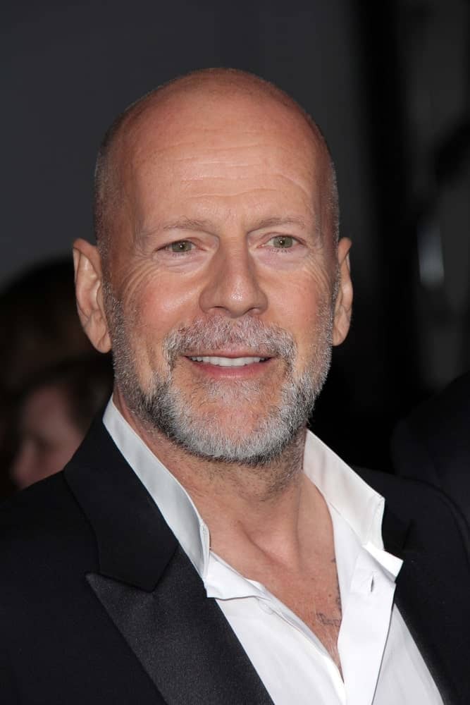 Bruce Willis will always be one of those guys with a signature look and style, and for him, his classic shaved head became his ultimate statement hairstyle. He has always been seen sporting a bald head and soon enough, it started looking quite natural and well-blended. Here he is rocking a bald head with gray facial scruff that makes him look utterly graceful and stylish. 
