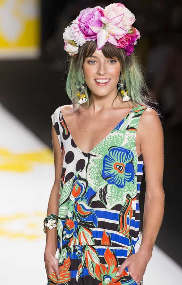 Model Chloe Norgaard gives tribute to nature as she walks the catwalk in mint and lime-green hair, adorned with a wreath of flowers. The model has her hair cut to shoulder length in a simple medium-length bob and rocks the style with a floral-printed dress. This is a wonderful look for spring. Silver-Lilac Pompadour