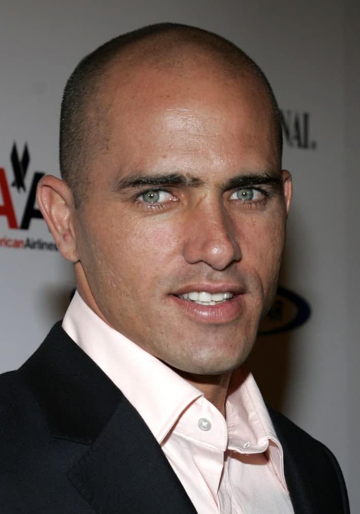 With those deep, fierce looking eyes and the mysterious half-smile, the American surfer Kelly Slater looks effortlessly chic in his shaved head. Once known as the “shaggy surfer dude”, he got rid of that title by shedding his locks! His nicely shaped head and his popping eyes enhance the look even more.