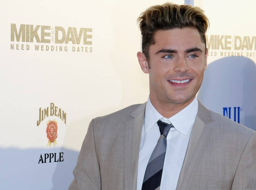 There is a reason why women love Zac Efron. With his highschool-boyfriend looks, the actor has stolen hearts all over the world ever since he first appeared in Disney’s “High School Musical.” He also knows how to dress up for the red carpet. Here, the actor is rocking a fluffed back pompadour, which has been set in place with some pomade or styling gel. To add more dimension to his hair, his stylist added some gold highlights on the front.