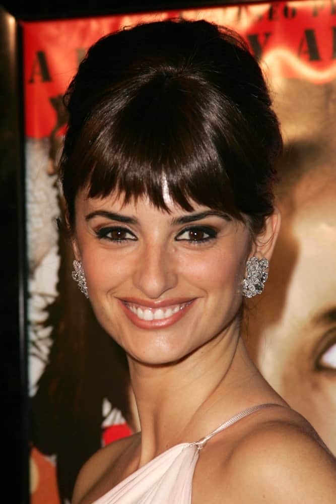 Although she is usually one for wearing her straight hair down and open, Penelope Cruz too couldn’t resist turning to updos on important occasions. Here she had chosen to secure her silky hair in a high bouffant and further adorned it with uneven, choppy bangs.