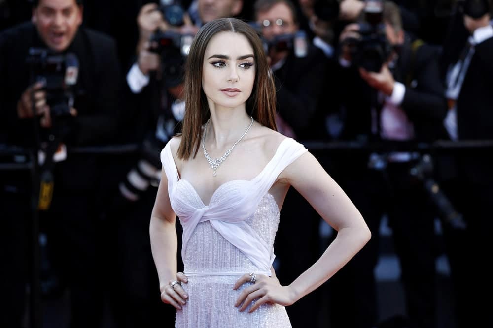 Lily Collins is as beautiful as she is talented. The actress rocked poker straight strands that were highlighted in dark cinnamon and red color from the mid-length to the bottom. She parted her hair deeply from the middle and wore her locks loose. Paired with her sequin-encrusted gown, the look is stunning.