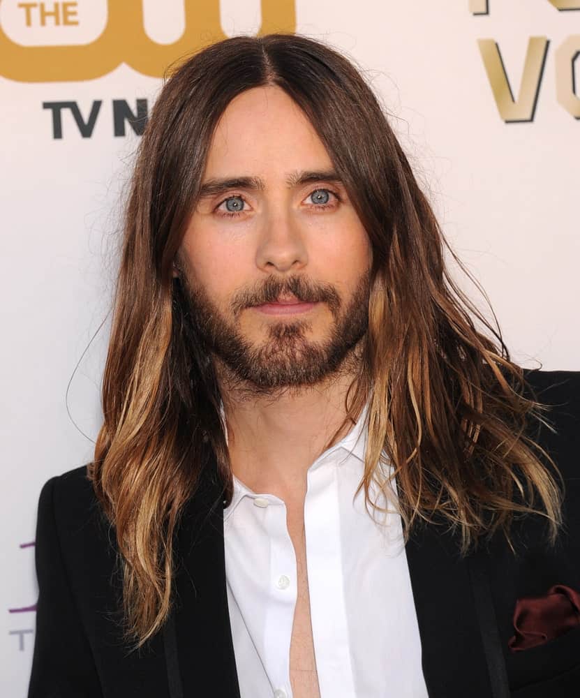 Jared Leto is the first name that comes to mind when you think of men with long hair. His hair here is really long, extending way beyond his shoulders and has a tad messy look. He has parted his hair in the middle where thick locks of highlighted hair fall on both sides. That rough, dark-colored beard greatly complements his long hair and makes him look absolutely dashing.