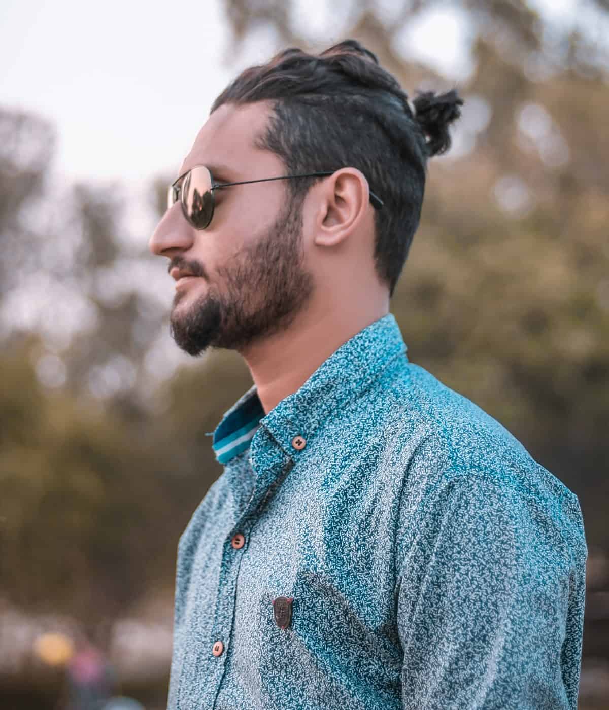 Looking for ways to add a bit more texture and dimensions to an otherwise plain fade haircut for men? Ask your barber to leave the top tresses long enough to form a small ponytail at the crest. However, ponytails for men are often frowned upon in some countries or even in certain groups of people, so watch out before trying one.