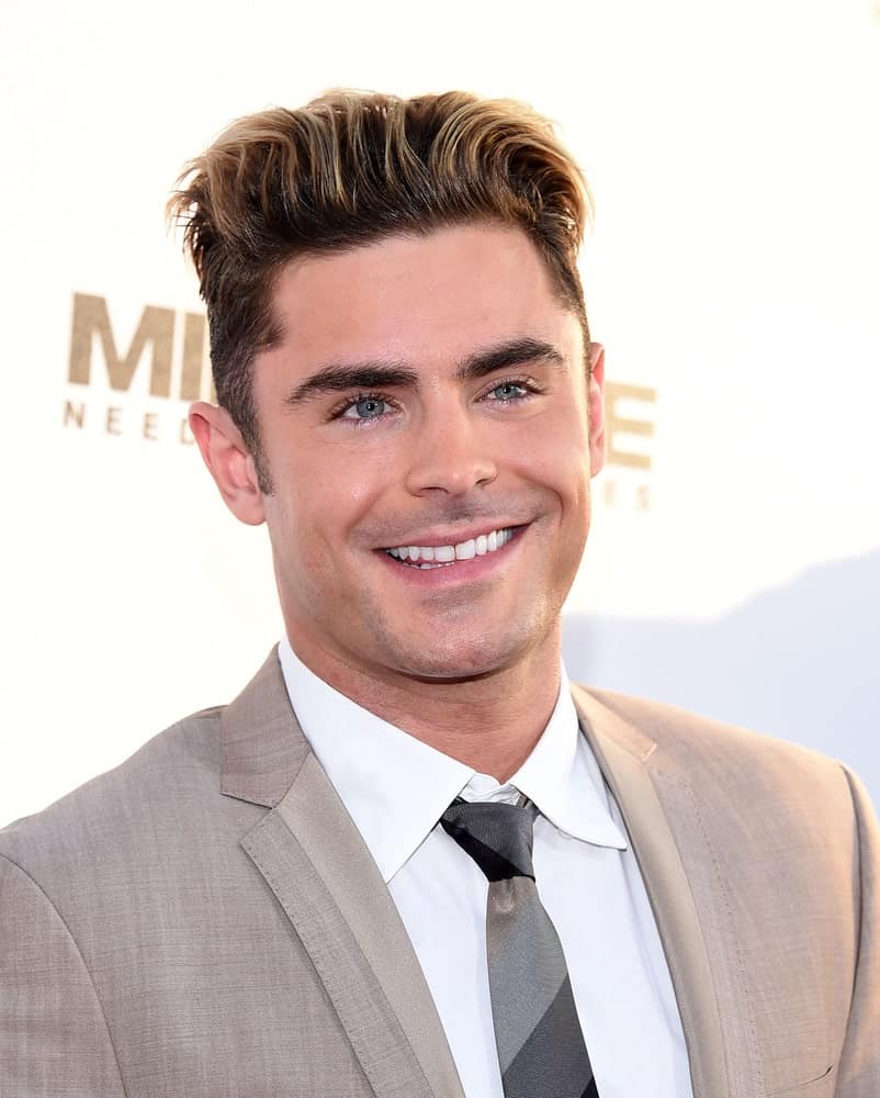 If ‘truly handsome’ had a face, that would be Zac Efron’s. Putting his million dollar smile, he looks simply gorgeous with his short brown hair that has been colored a really nice golden-brown from the top. This haircut not only perfectly goes with his face cut, but the addition of the blonde-brown highlights ups his hair game. 